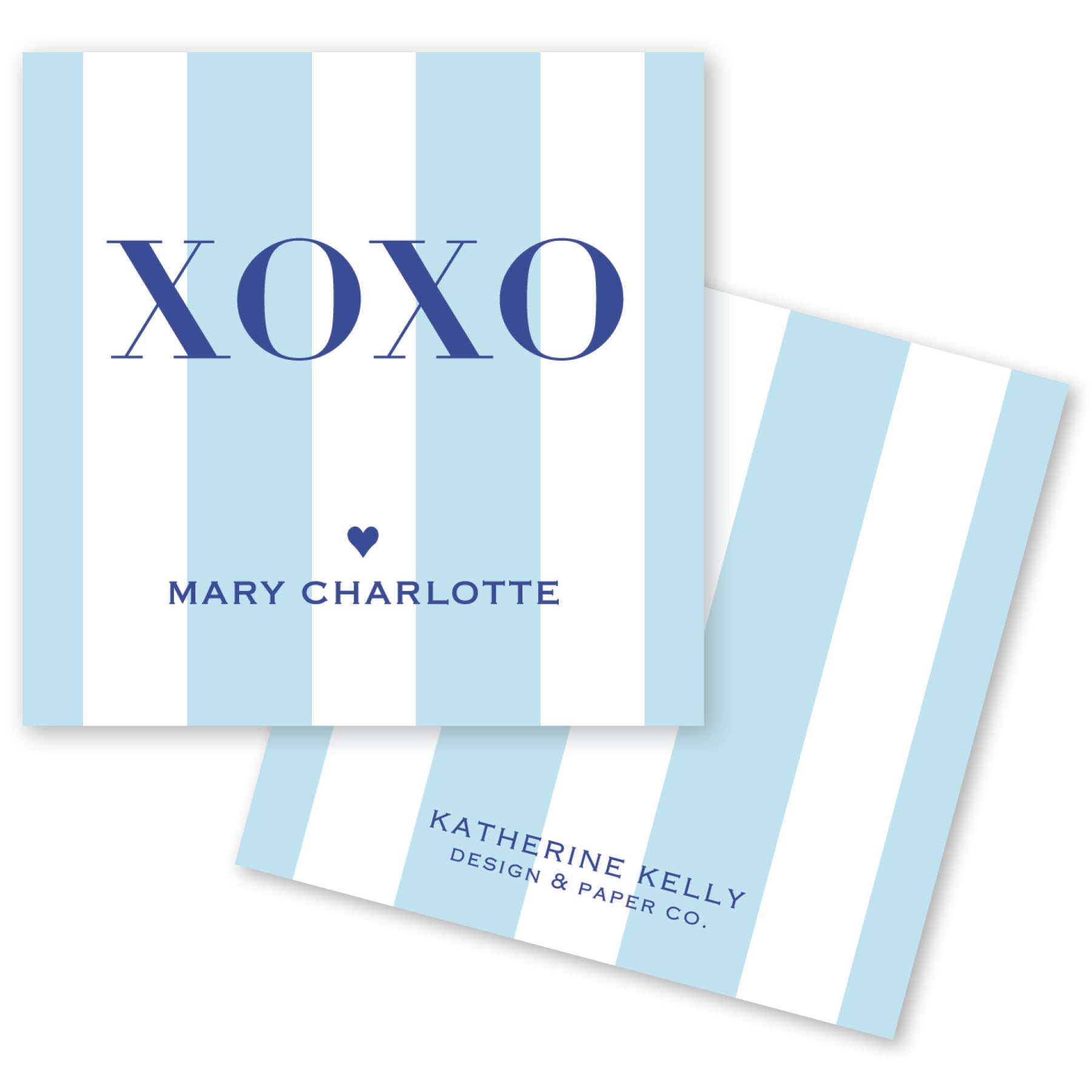a light blue and white striped card with the word "XOXO" prominently displayed in the center. Below the word "XOXO", the name "Mary Charlotte" is written, and at the bottom, the text "KATHERINE KELLY DESIGN & PAPER CO." is visible.