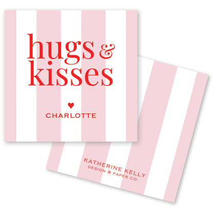 a pink and white striped card with the text "hugs & kisses" and " Charlotte" printed on it.