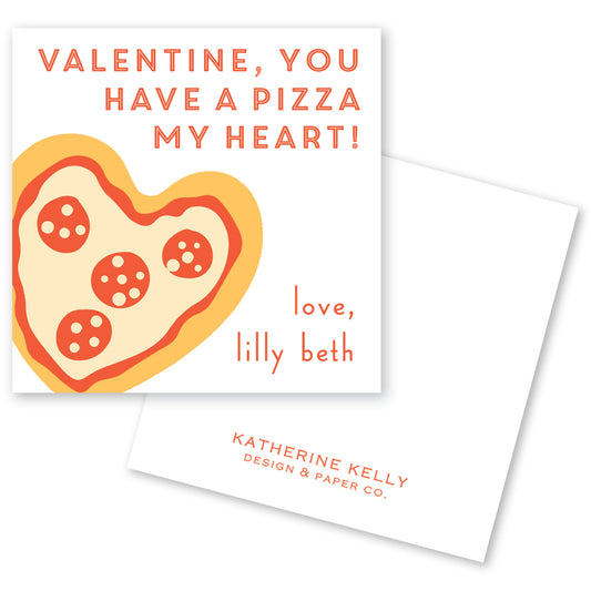 The image is a Valentine's Day card featuring a heart-shaped pizza with pepperoni slices. The card has a message that reads "Valentine, you have a pizza my heart!" and includes the name "Lilly Beth" along with the company name "Katherine Kelly Design & Paper Co."