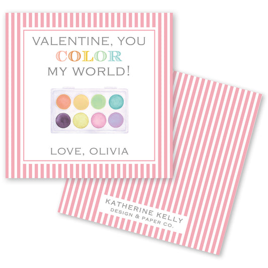 The image is a Valentine's Day card with a pink and white striped background. The card features a colorful paint palette and a message that reads "Valentine, you color my world!" The card also includes a name and a logo for "Katherine Kelly Design & Paper Co."