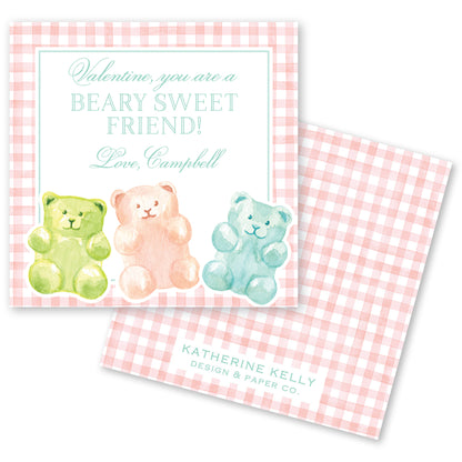 The image is a Valentine's Day card featuring three teddy bears in different colors - green, pink, and blue - sitting together on a pink and white checkered background.