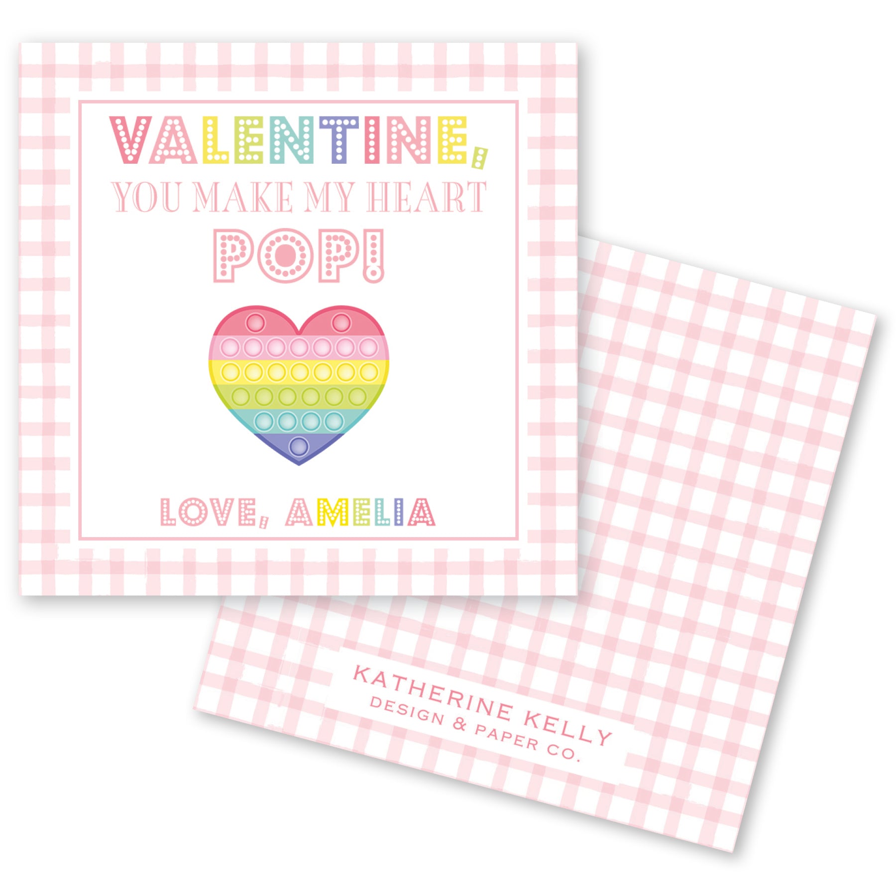 The image is a Valentine's Day card with a pink and white checkered background. The card features a heart-shaped pop-up design and text that reads "Valentine! You make my heart pop!" The card also includes the name "Love, Amelia" and the logo of "Katherine Kelly Design & Paper Co."
