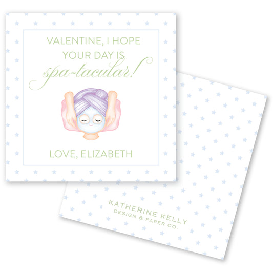 a Valentine's Day card with a purple-haired person wearing a face mask, surrounded by stars. The card has a message that reads "Valentine, I hope your day is spa-tacular!" and includes the names "Love, Elizabeth" and " Katherine Kelly Design & Paper Co."