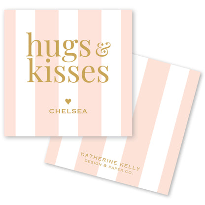 a pink and white striped card with the text "hugs & kisses" and " Chelsea" printed on it.