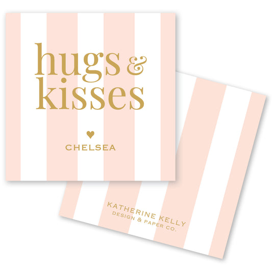 a pink and white striped card with the text "hugs & kisses" and " Chelsea" printed on it.