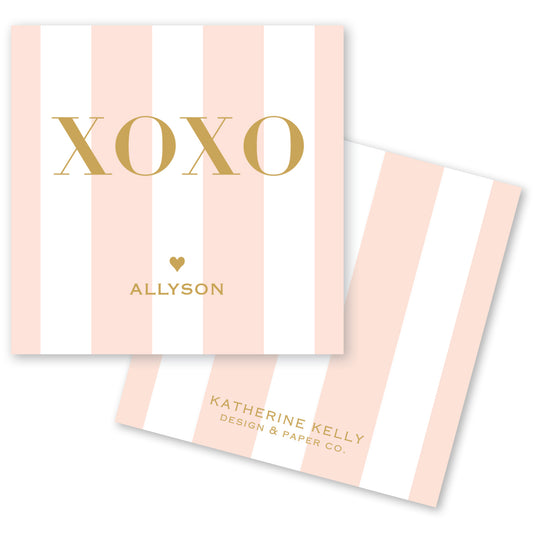 a pink and white striped card with the word "XOXO" written on it.