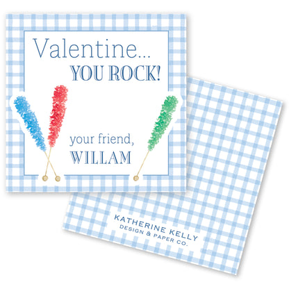 The image is a Valentine's Day card with a blue and white checkered background. The card features a message that reads "Valentine... YOU ROCK!" and includes illustrations of candy canes. The card also includes the text "your friend, WILLAM" and "KATHERINE KELLY DESIGN & PAPER CO."