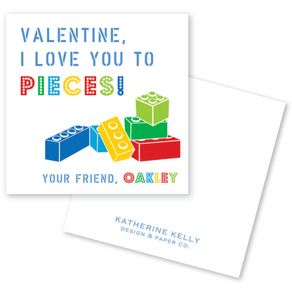 The image is a Valentine's Day card with a colorful illustration of building blocks and the text "Valentine, I love you to pieces!"