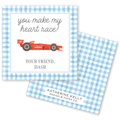 The image is a greeting card with a checkered border and a red race car illustration. The card has a message that reads "you make my heart race!" and a tagline that says "YOUR FRIEND, DASH". The card also features the name "KATHERINE KELLY" and the logo "DESIGN & PAPER CO."