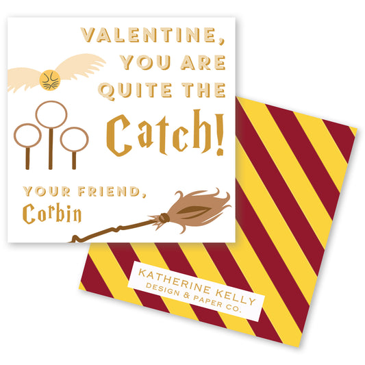 The image is a Valentine's Day card featuring a golden snitch, a flying broomstick, and a golden holly leaf. The card has a message that reads "Valentine, you are quite the catch! Your friend, Corbin" and includes the logo of "Katherine Kelly Design & Paper Co."