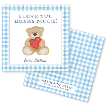 The image is a greeting card with a teddy bear holding a red heart. The card has a blue and white checkered border and a message that reads "I LOVE YOU BEARY MICH!" The card also includes a name and logo for "KATHERINE KELLY DESIGN & PAPER CO."