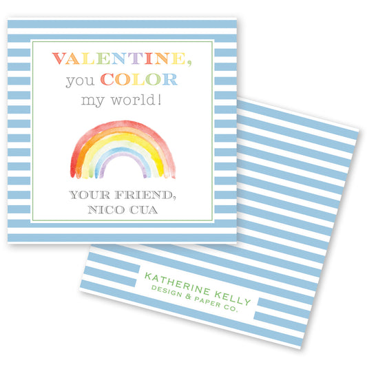 The image is a Valentine's Day card with a blue and white striped background. The card features a watercolor illustration of a rainbow and a message that reads "Valentine, you color my world!" The card also includes a signature and a logo for "Katherine Kelly Design & Paper Co."
