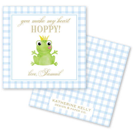 The image is a greeting card featuring a green frog wearing a crown, with the text "you make my heart HOPPY!" and "love, Samuel" written on it.